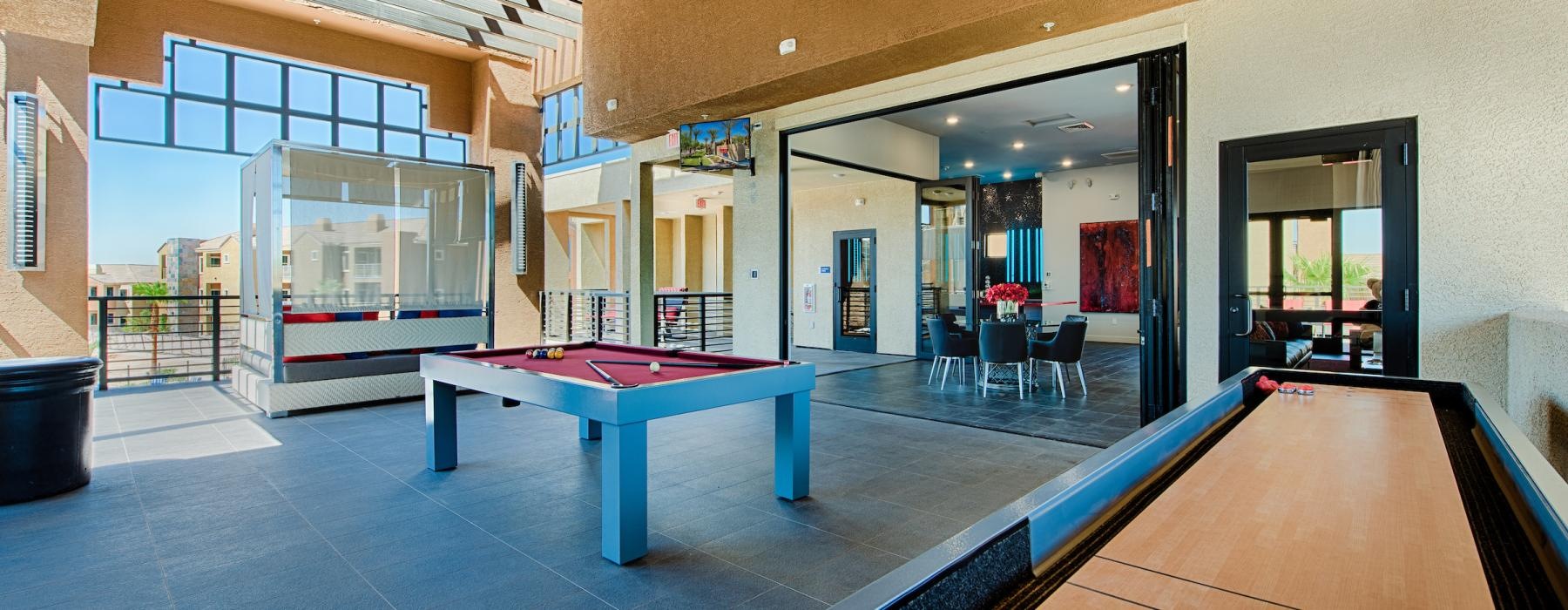 a gameroom with a pool table and shuffleboard