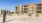 a sand volleyball court in front of an apartment building