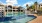 a swimming pool in front of a large building