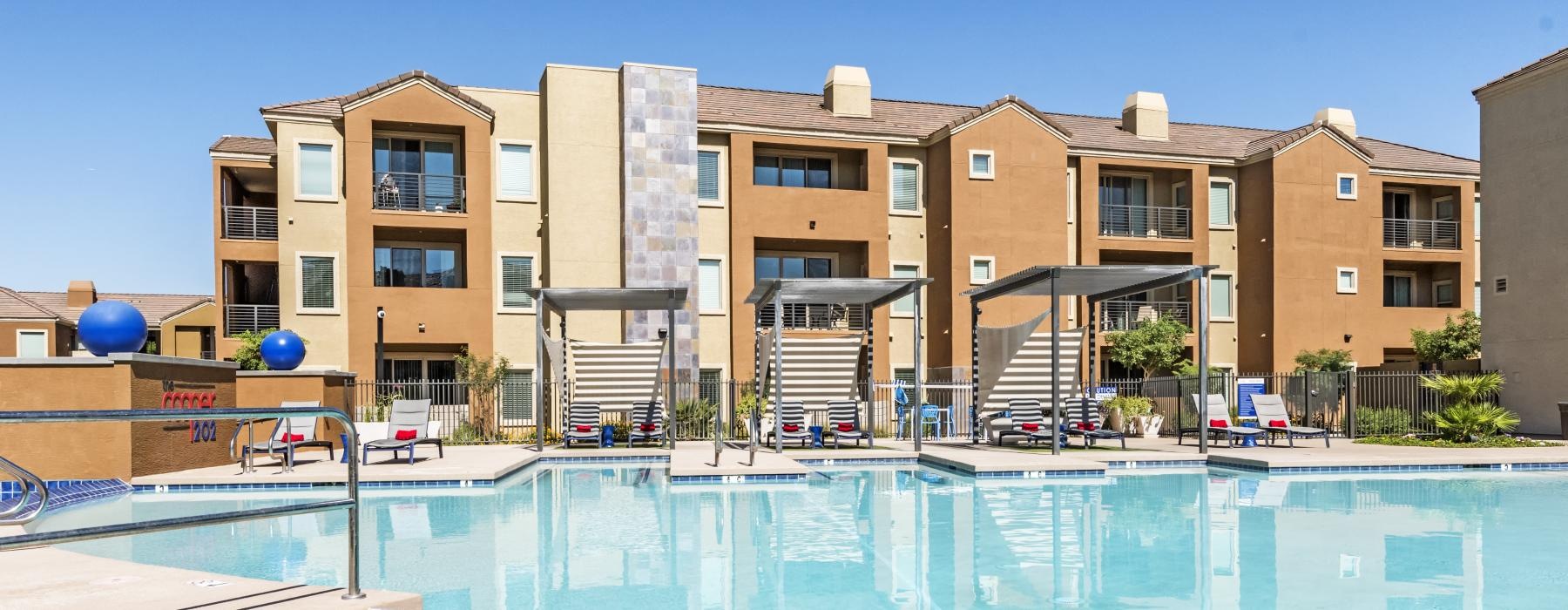 a swimming pool in front of a large building